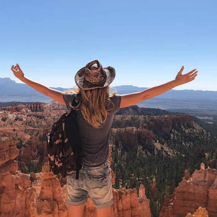 https://tammice.s3.amazonaws.com/prod/news/20/019f5d6aba4671d2bdf39984742a0627/rear-view-woman-with-arms-outstretched-looking-rock-formations-bryce-canyon.jpg